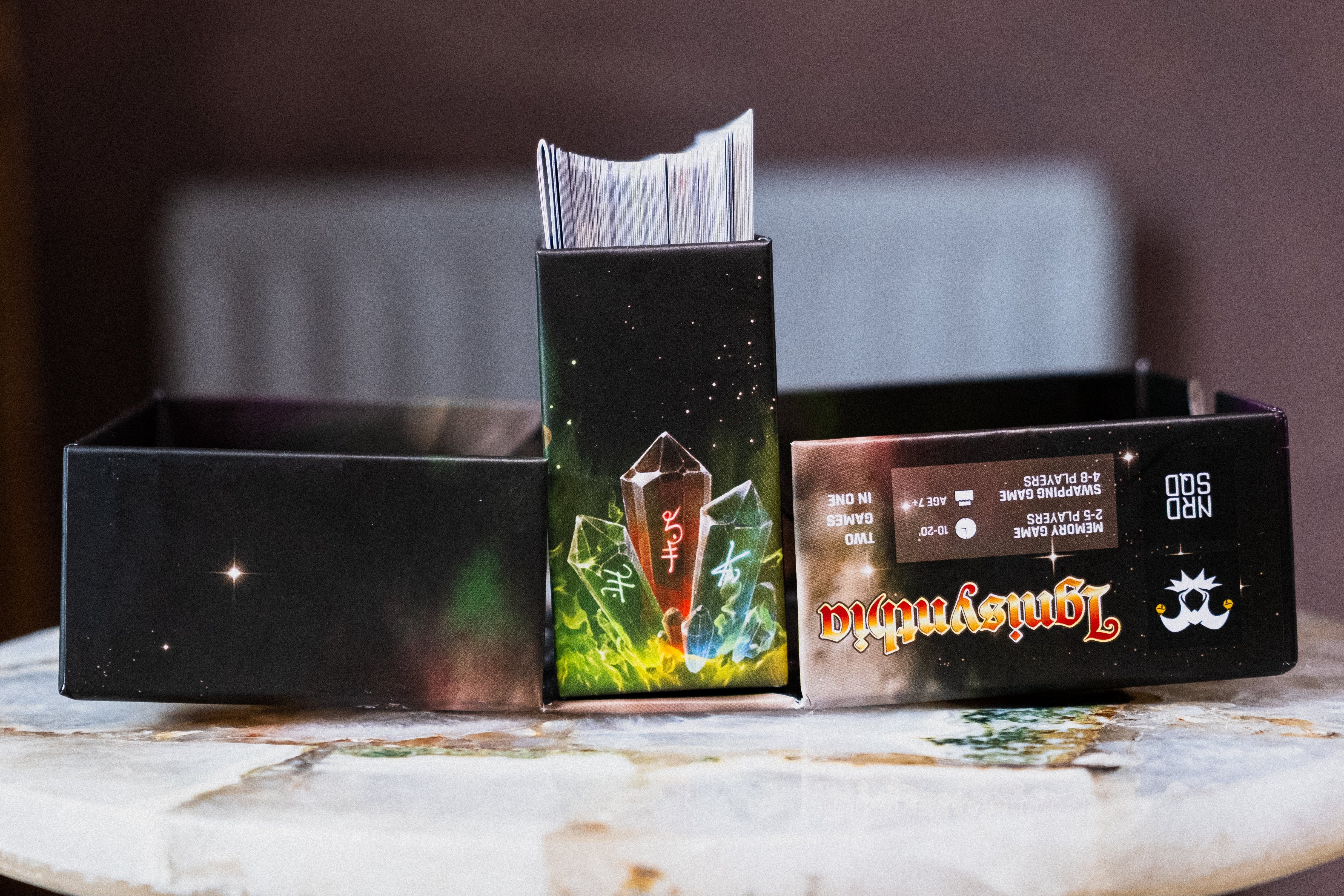 open card game box with cards poking out of the top
