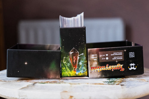 open card game box with cards poking out of the top