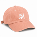 Peach orange baseball cap with white embroidered Myrth M monogram on front